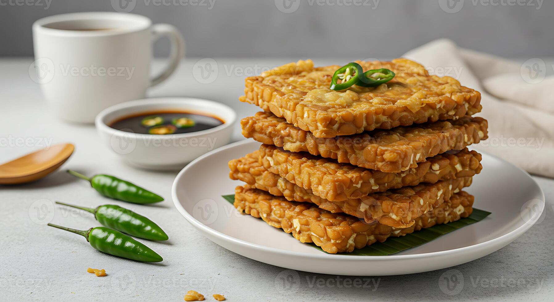 Fried Food Stacked with Chili Peppers and Dipping Sauce on a White Plate photo