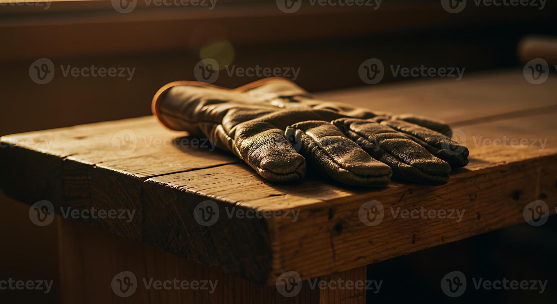 Leather Glove Resting on Wooden Bench in Warm Natural Light photo