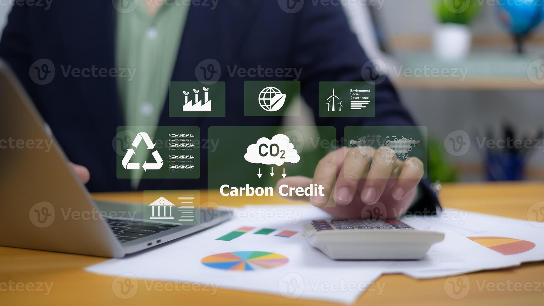 Environmental responsibility, sustainable business practices, renewable energy, and corporate governance. Green business. A person interacting with a holographic display of ESG and Carbon Credit icons photo