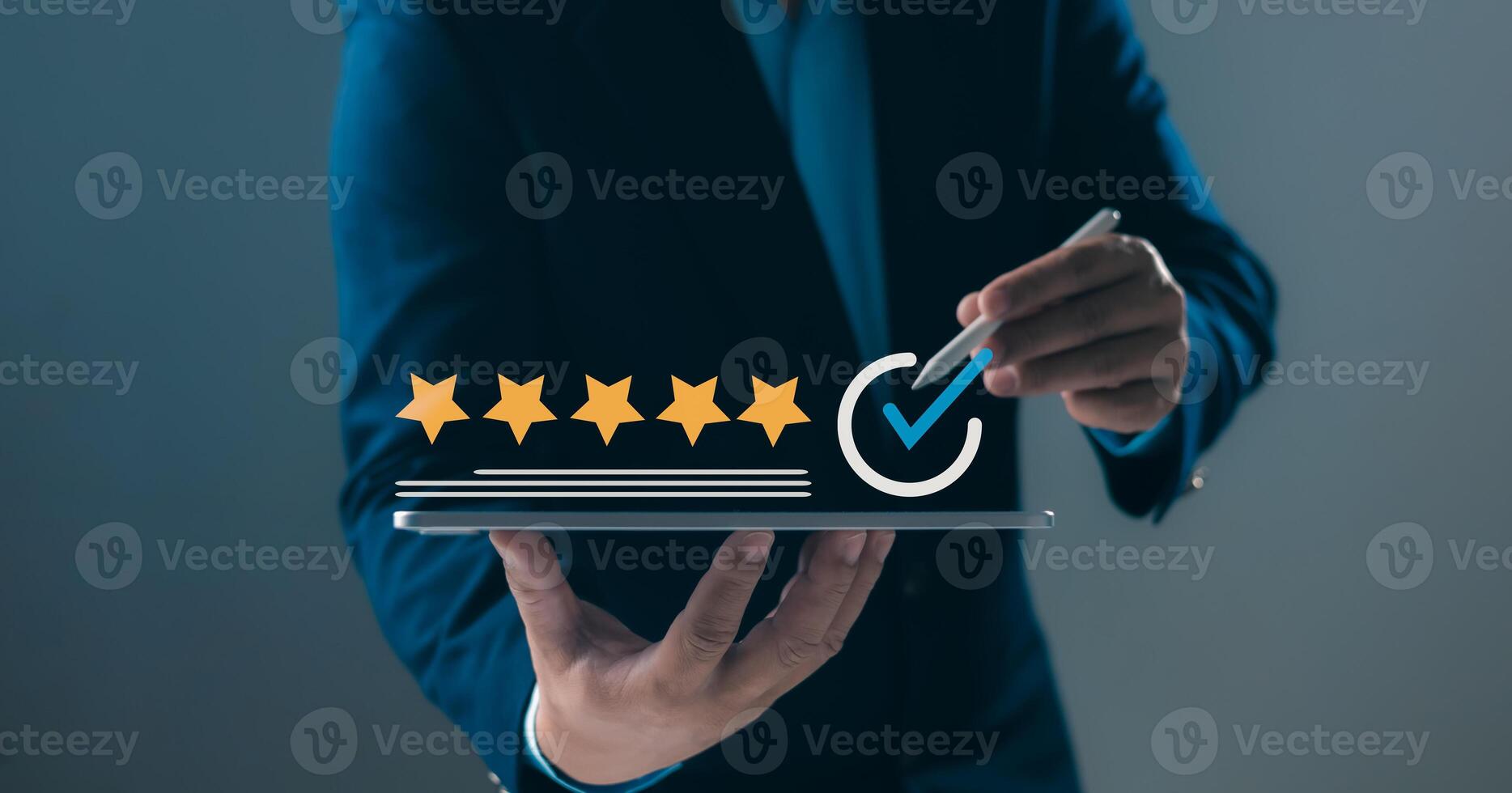 Excellent customer reviews, high service ratings, quality assurance, successful performance in business, satisfaction, Person holding a tablet displaying five golden stars and a blue checkmark. photo