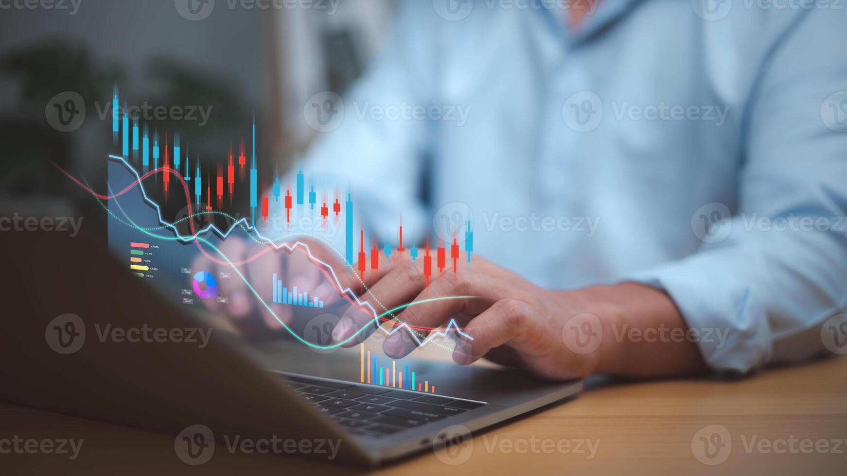 Businessman analyzing financial charts and stock market data on a laptop with candlestick graphs and digital analytics. Focus on investment, trading strategy, financial growth, decision-making. photo