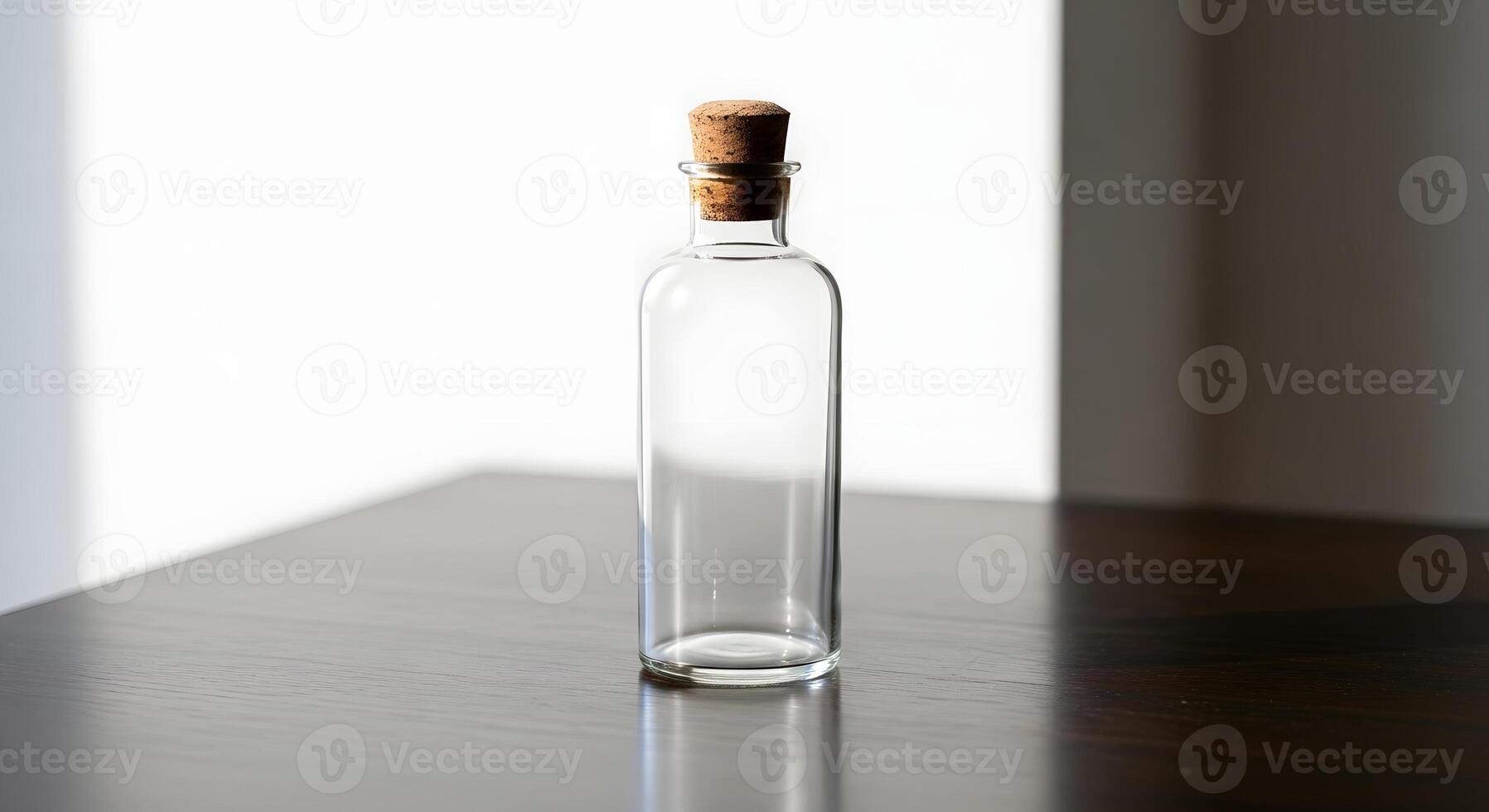 A glass bottle with a cork on top photo