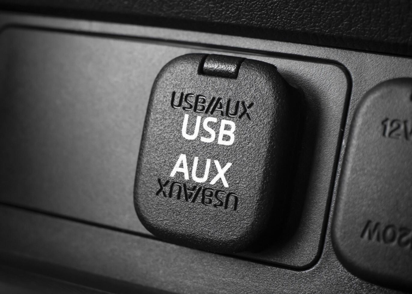 Closeup of car USB port and AUX input. Automotive connectivity in-car audio and charging. photo
