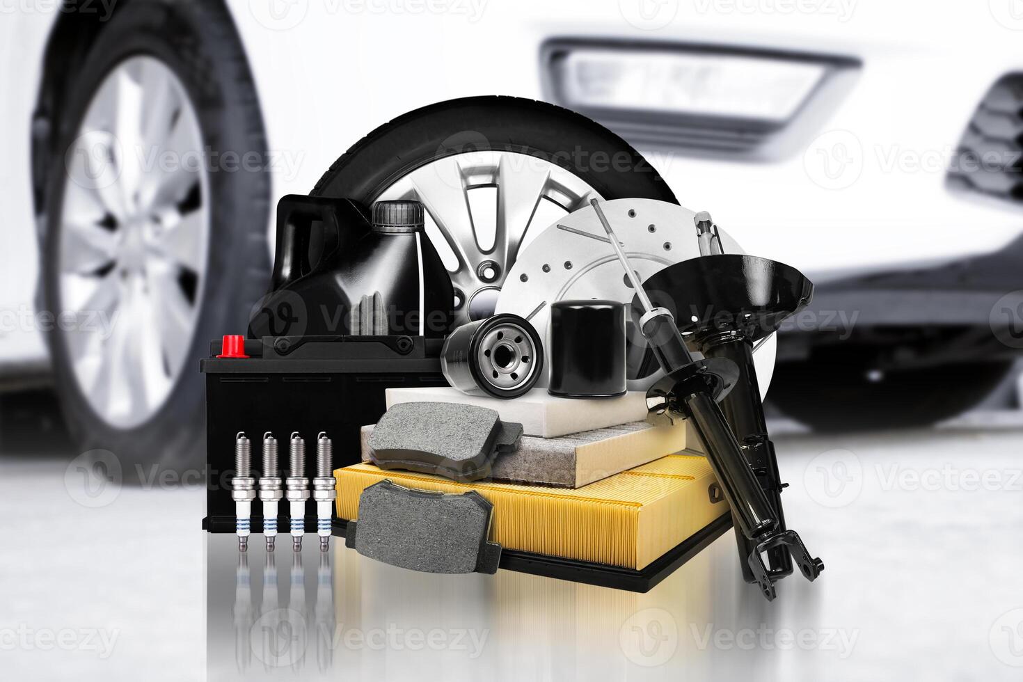 Car parts and auto maintenance spare parts, automotive spare part for car service garage with a white car blurred on background. photo