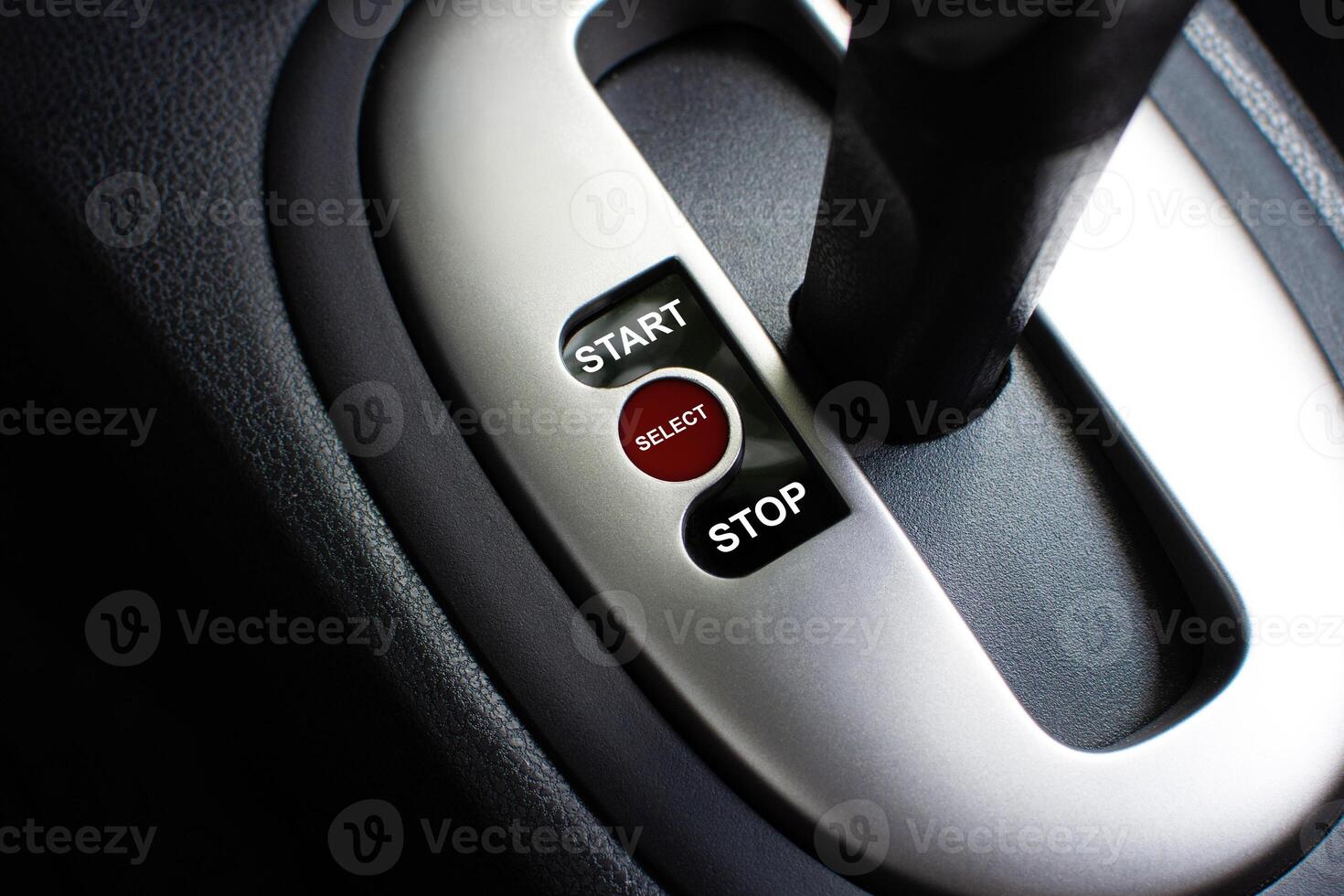Selector Switch Lever, A close-up of a car gear shift console with START, SELECT, and STOP buttons. It may mean a symbol of start or stop. photo