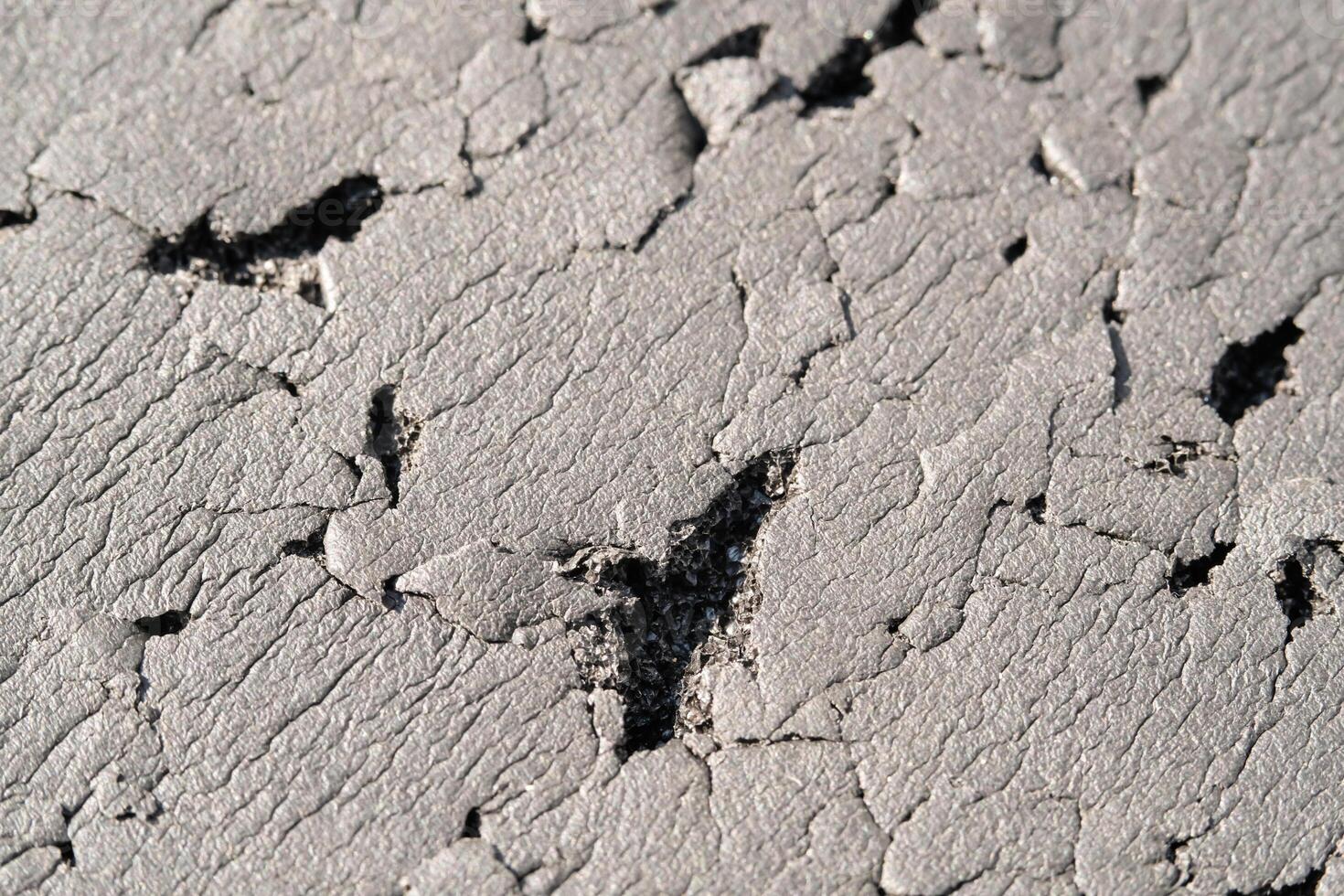 Close-up shot of black foam full of scratches. Textured background of black foam scratched by cat. Abstract black backgrounds. Soft foam full of wrinkles and scratches. Negative space photo