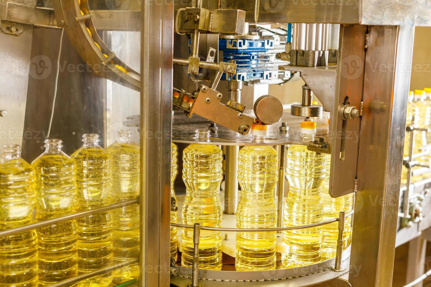 Automated Sunflower Oil Bottling Line in Modern Factory with Industrial Machinery and Transparent Bottles photo