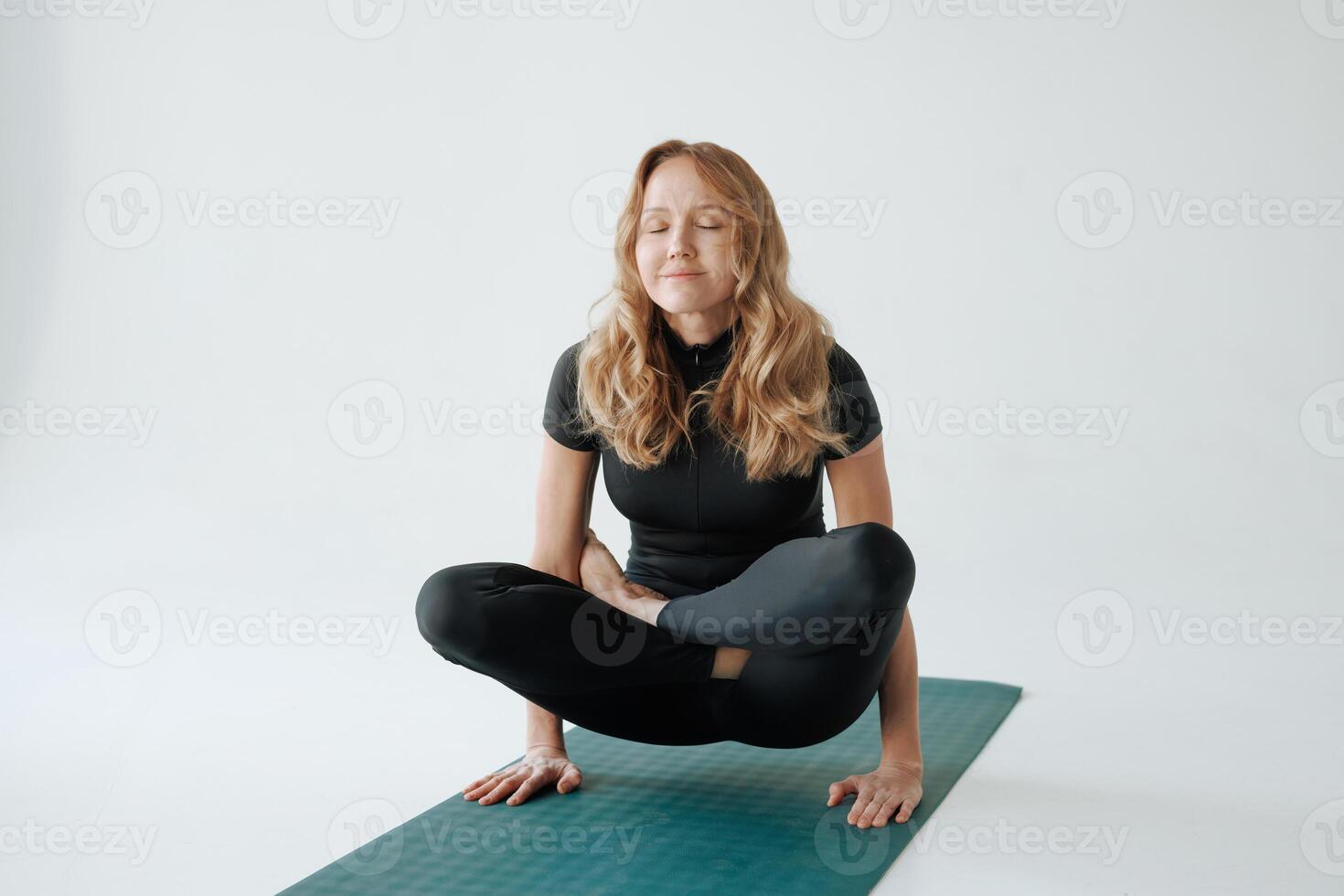Mature woman practicing yoga pose on mat in studio, balance and strength training for healthy lifestyle photo