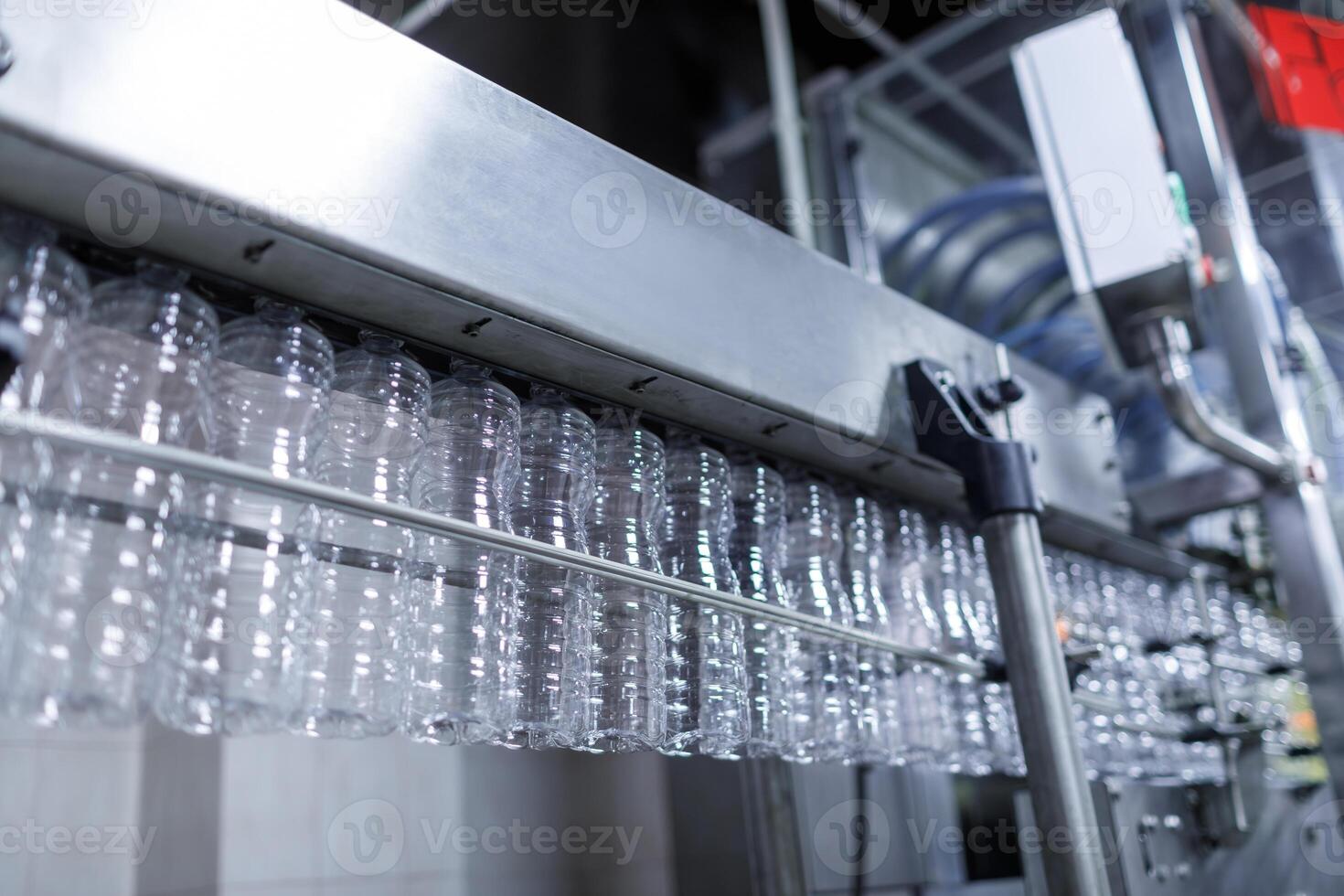 Plastic Bottle Production Line in Modern Factory with Empty Containers on Automated Conveyor System photo