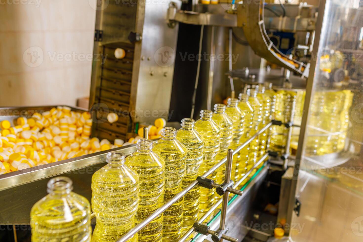 Automated Sunflower Oil Bottling Line in Modern Factory with Transparent Bottles and Industrial Equipment photo