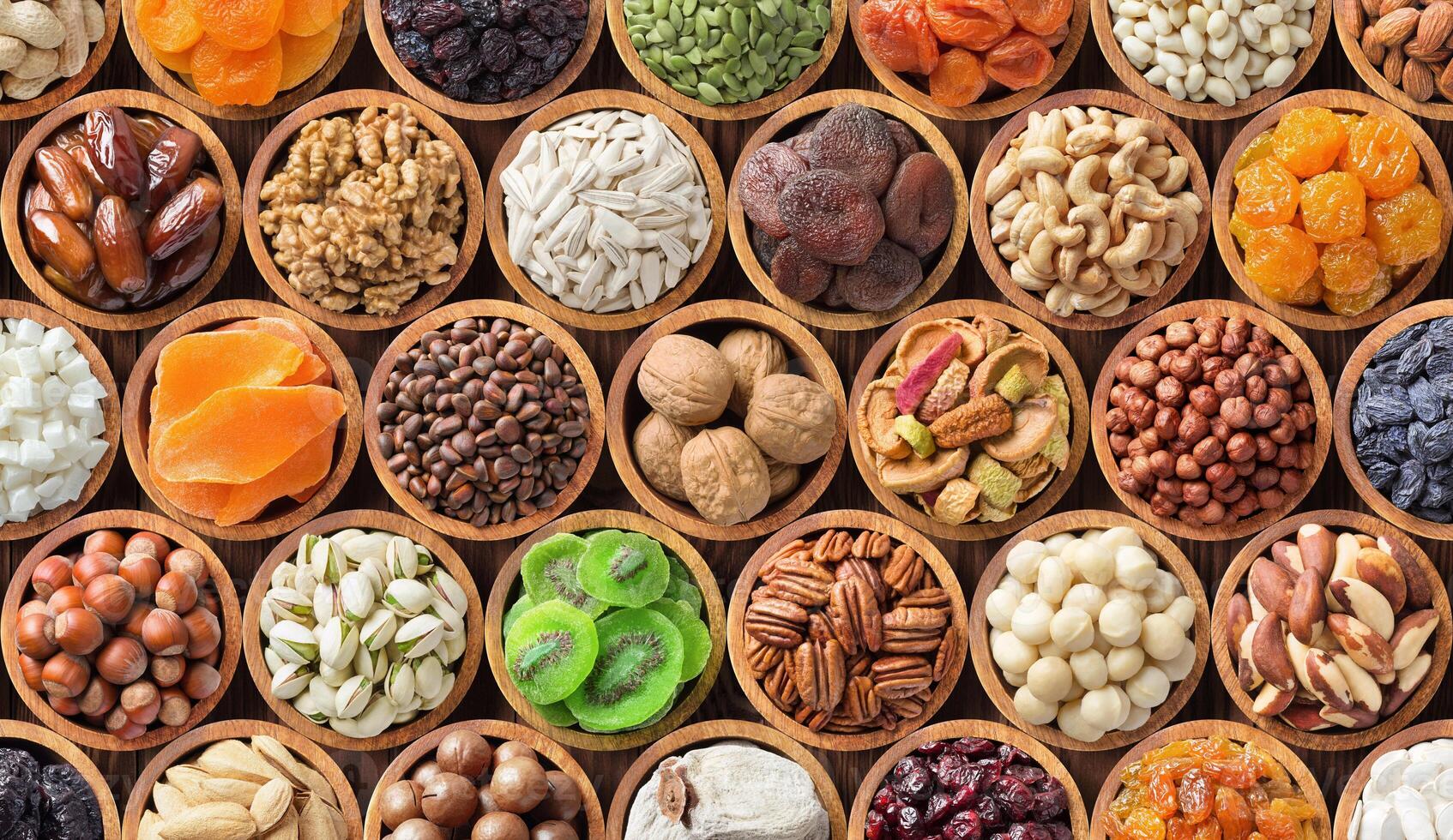 different kinds dried fruits and nuts background. colorful food, healthy snacks. photo