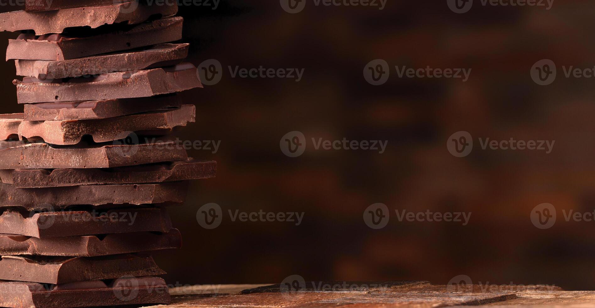 stack of broken dark chocolate. sweet food tower photo
