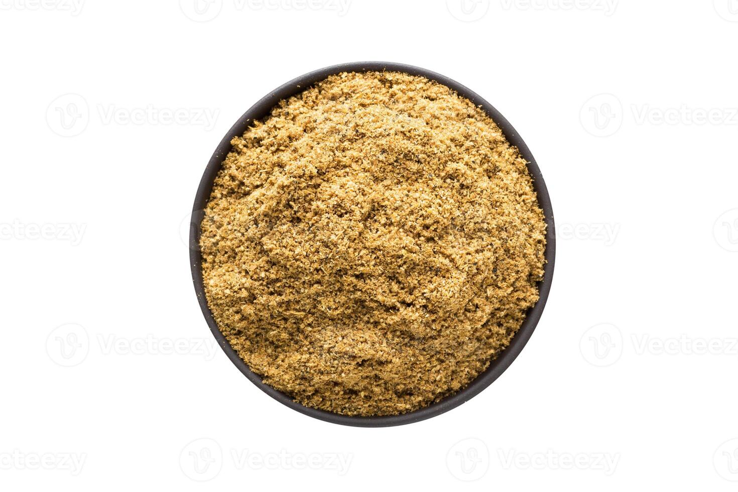 Cumin powder in clay bowl isolated on white background. Seasoning or spice top view photo