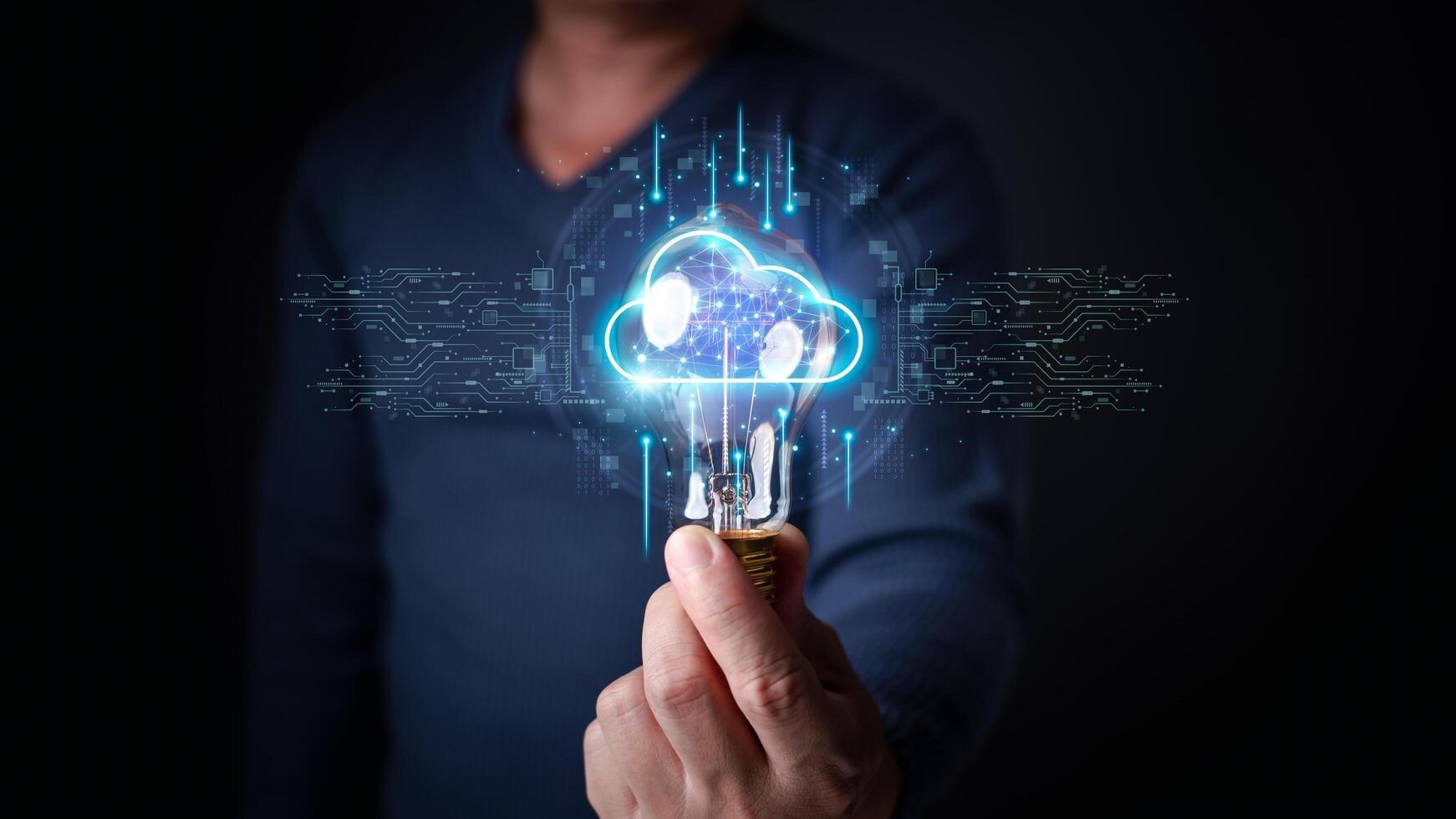 a person holding a lightbulb with a glowing, futuristic cloud hologram inside, surrounded by digital circuitry and connections, symbolizing innovation and cloud-based technology. photo