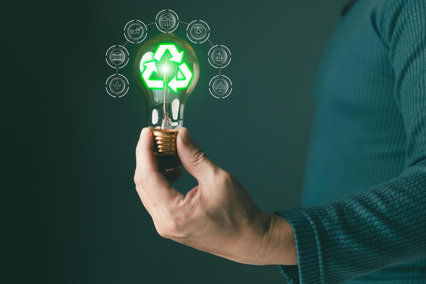 hold lightbulb to sustainability and recycling,climate change,ecology friendly investment,ESG environment social governance,Green Business Innovation and Sustainable Development concept. photo