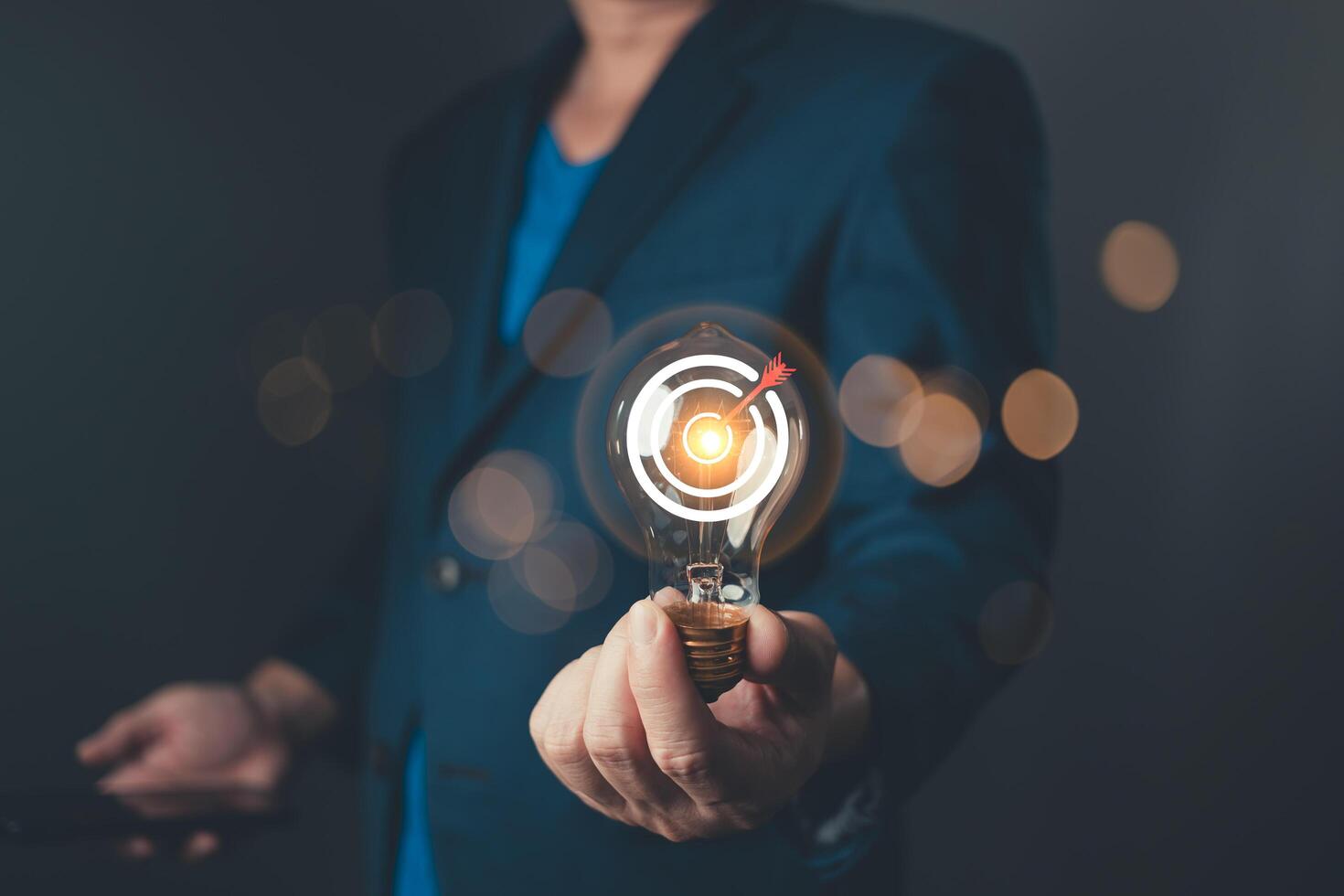 A professional hold glowing lightbulb with a target symbol, representing a business goal and strategic plan, showcasing innovation, focus, and determination for success in a competitive environment. photo