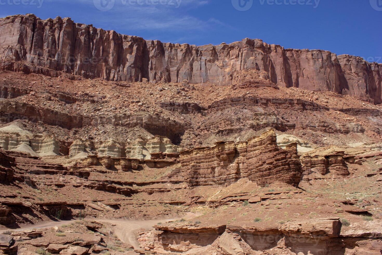 Majestic rock formations under a clear blue sky in a desert landscape during midday light photo