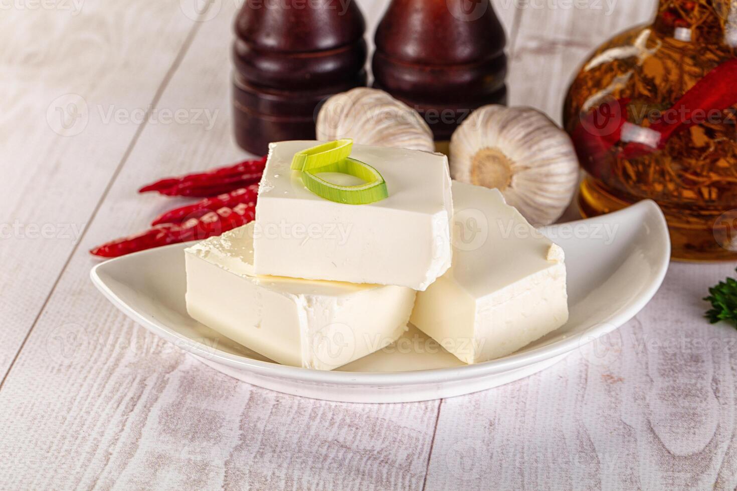 A white plate with some cheese and some peppers photo