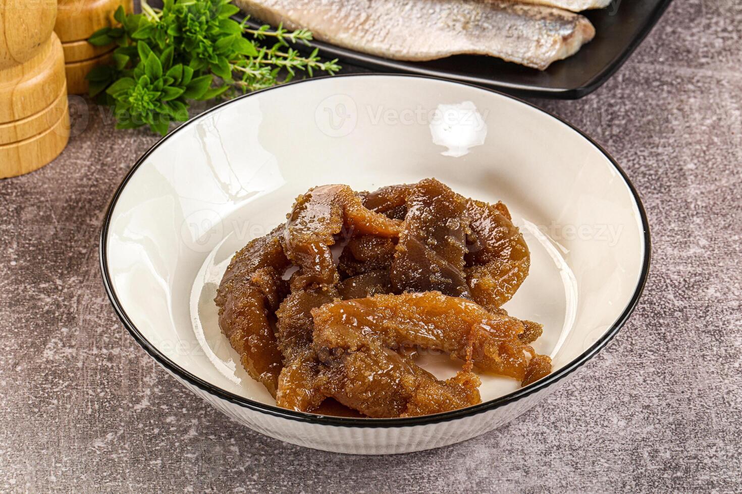 A bowl of fish and some other ingredients photo