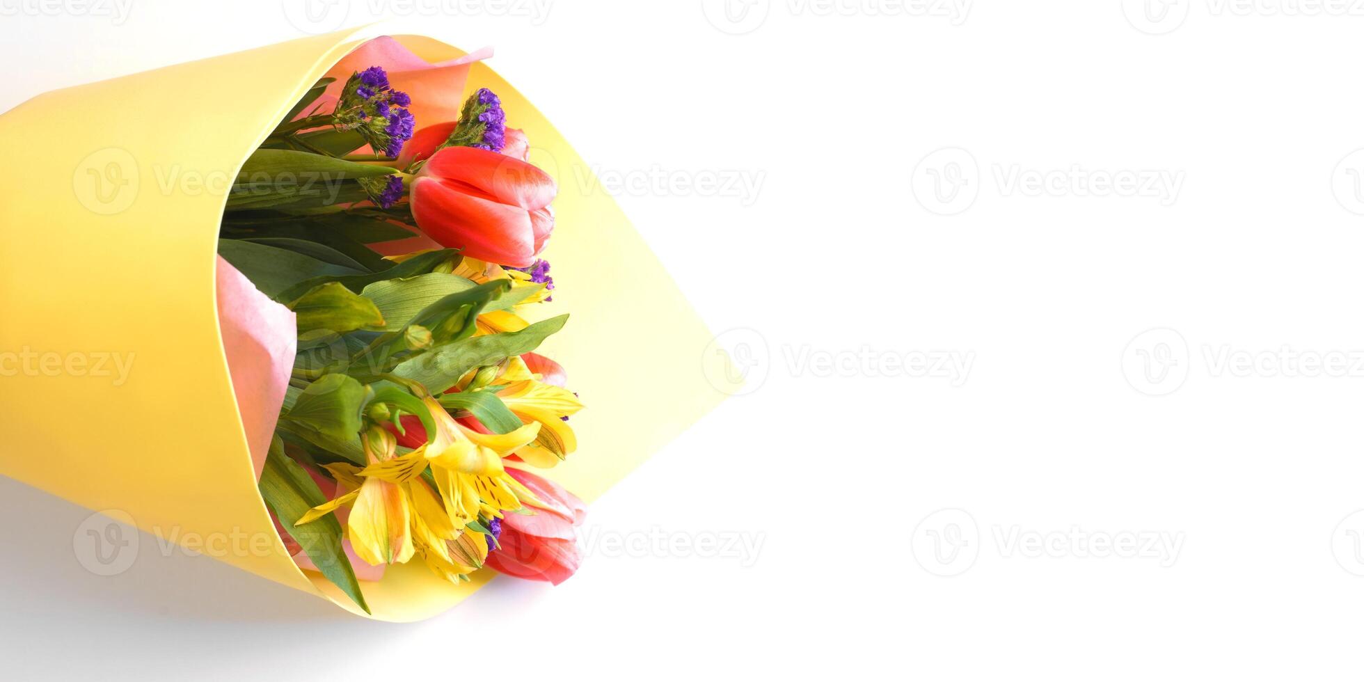 A yellow paper bag with flowers in it photo