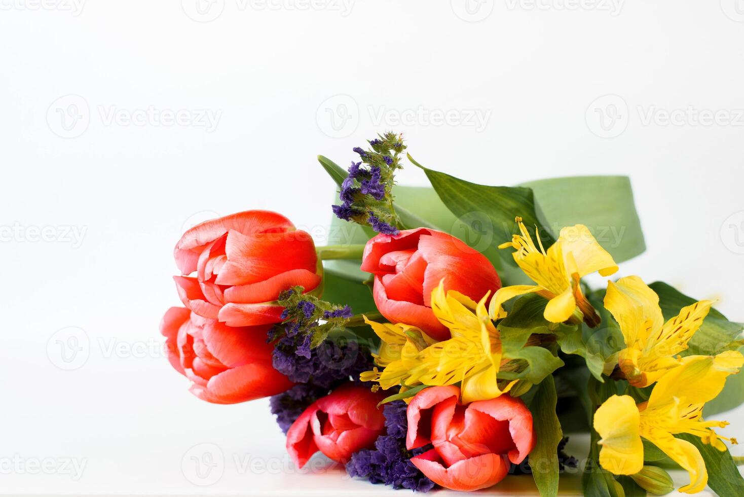A bouquet of flowers on a white surface photo