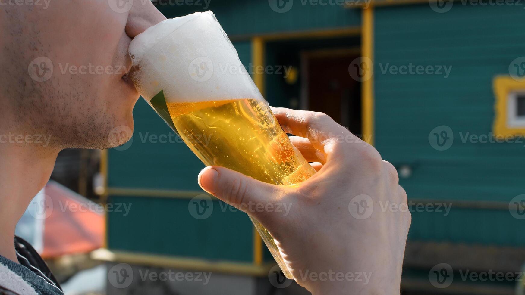 A man drinking a beer photo