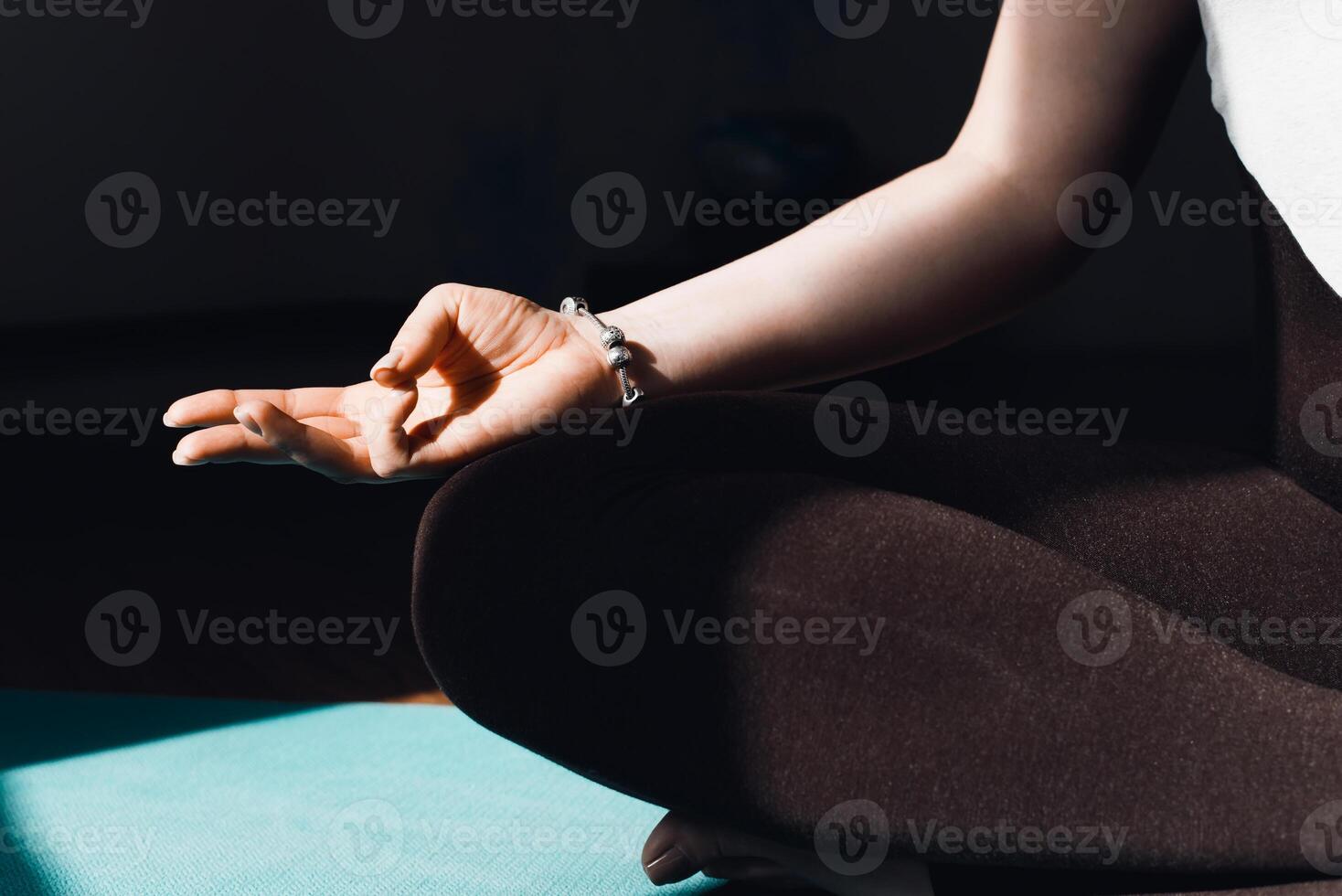 A woman sitting in a yoga pose with her hands open photo