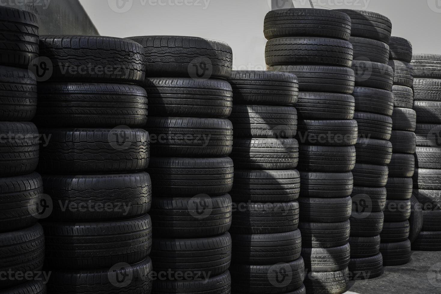 Stacks of Used Car Tires in Outdoor Storage Yard photo