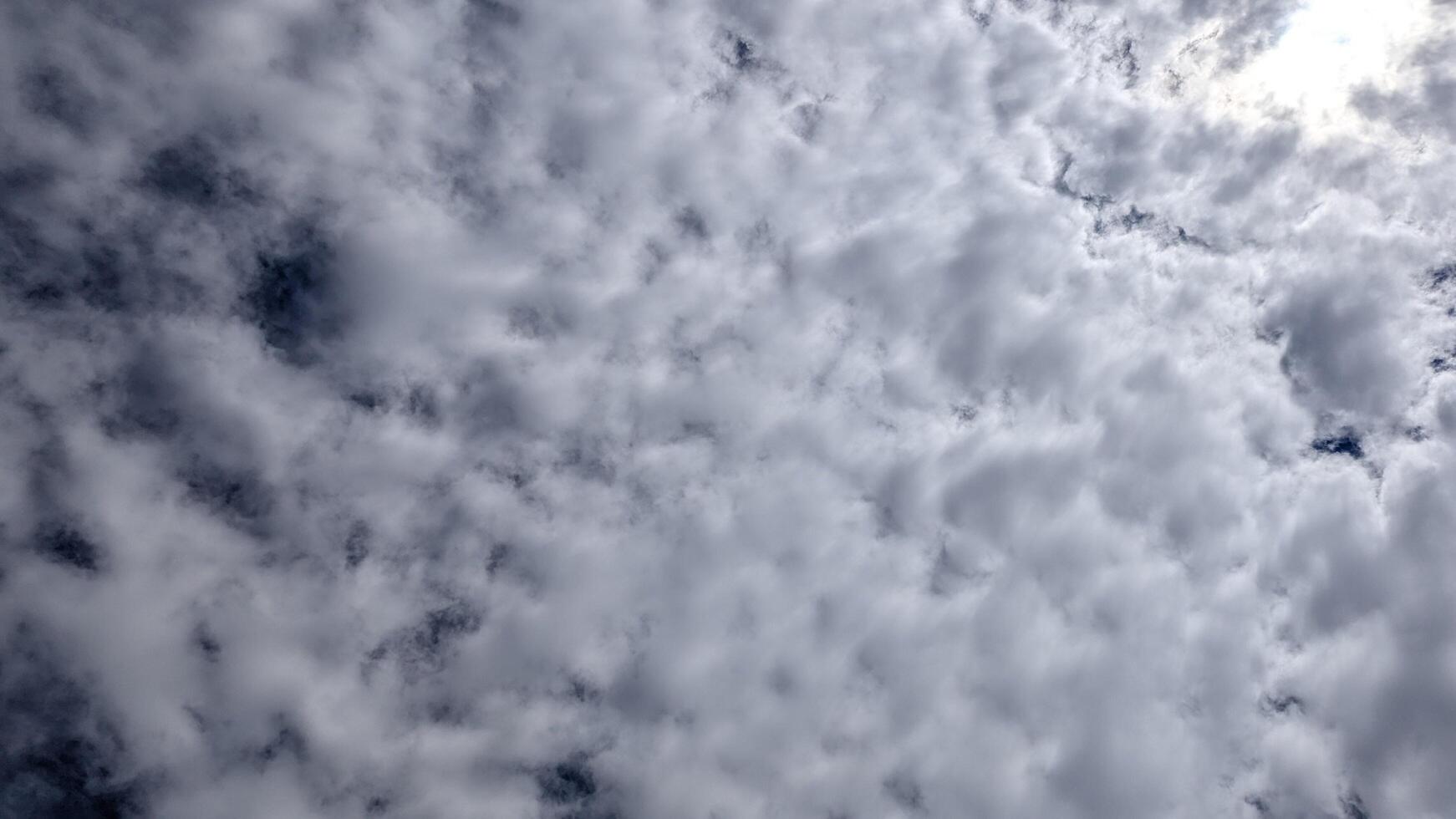 Dramatic Cloudy Sky A Textured Cloudscape with Sunlight Peeking Through photo