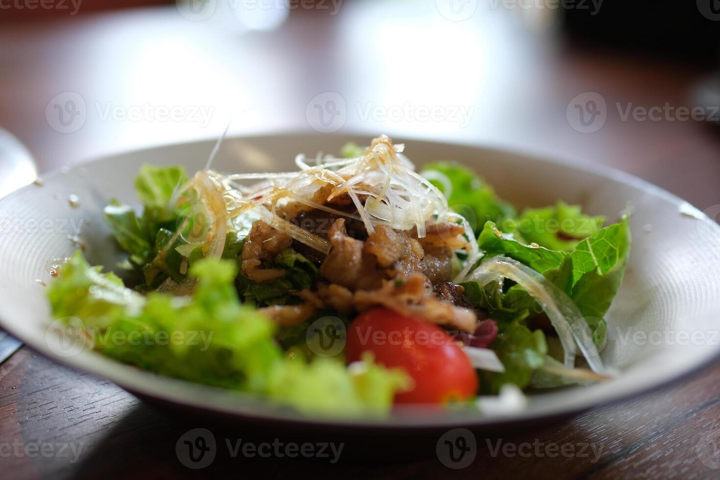 pour soy sauce over the salad egg salad with tuna Fresh salad with vegetables, dressing pouring over for vibrant taste photo