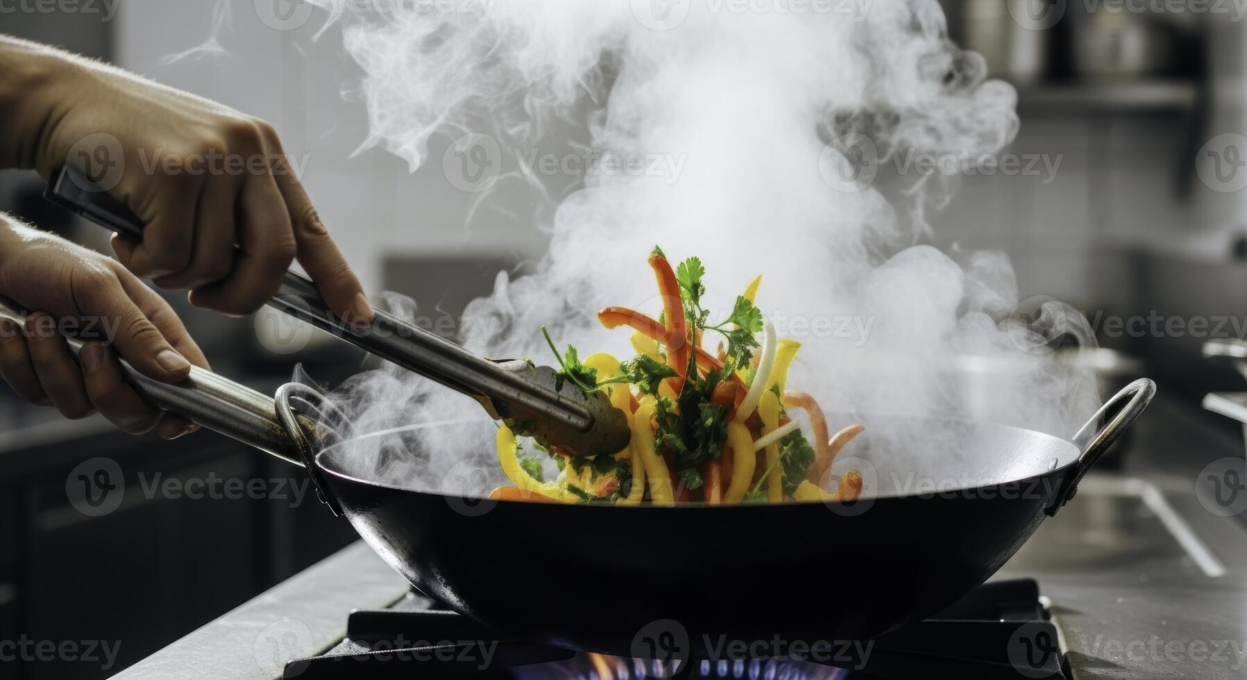 Close up of a chef hands stir frying colorful vegetables in a steaming wok photo