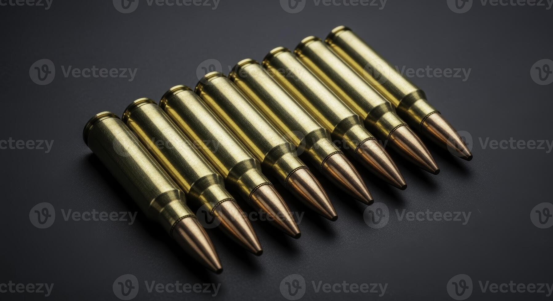 Eight 7.62 caliber rifle cartridges in a row on a dark surface photo