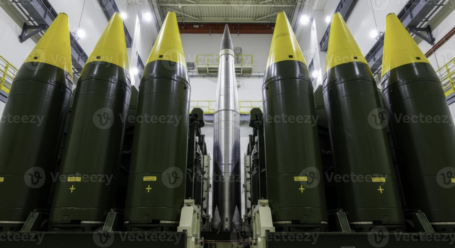 Six massive intercontinental ballistic missiles standing in a secure industrial facility photo