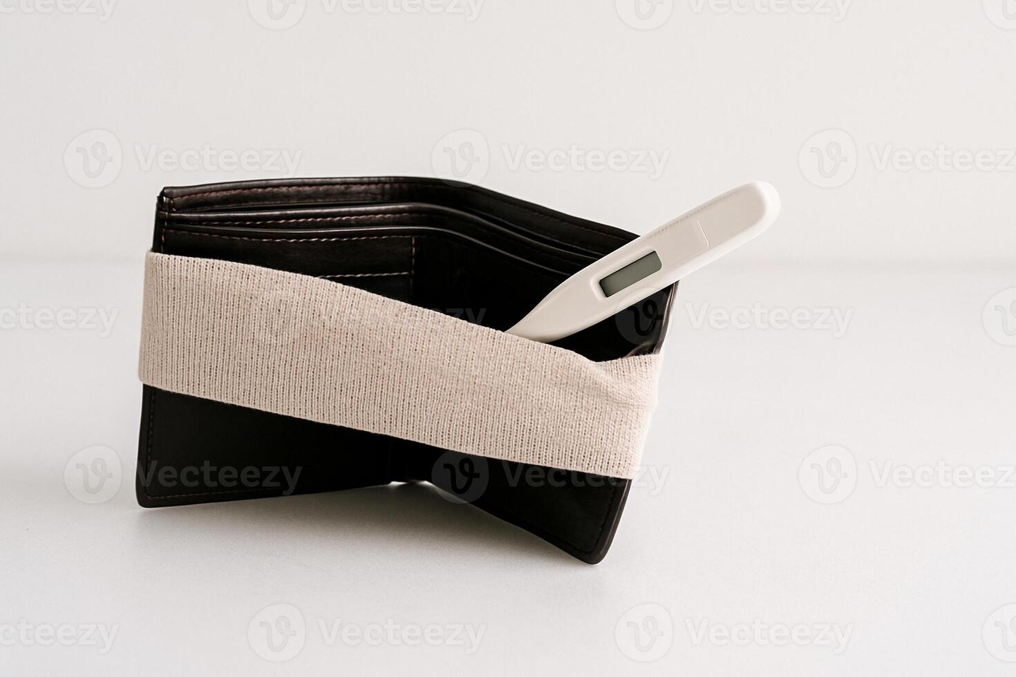 Empty wounded wallet with bandage on white photo