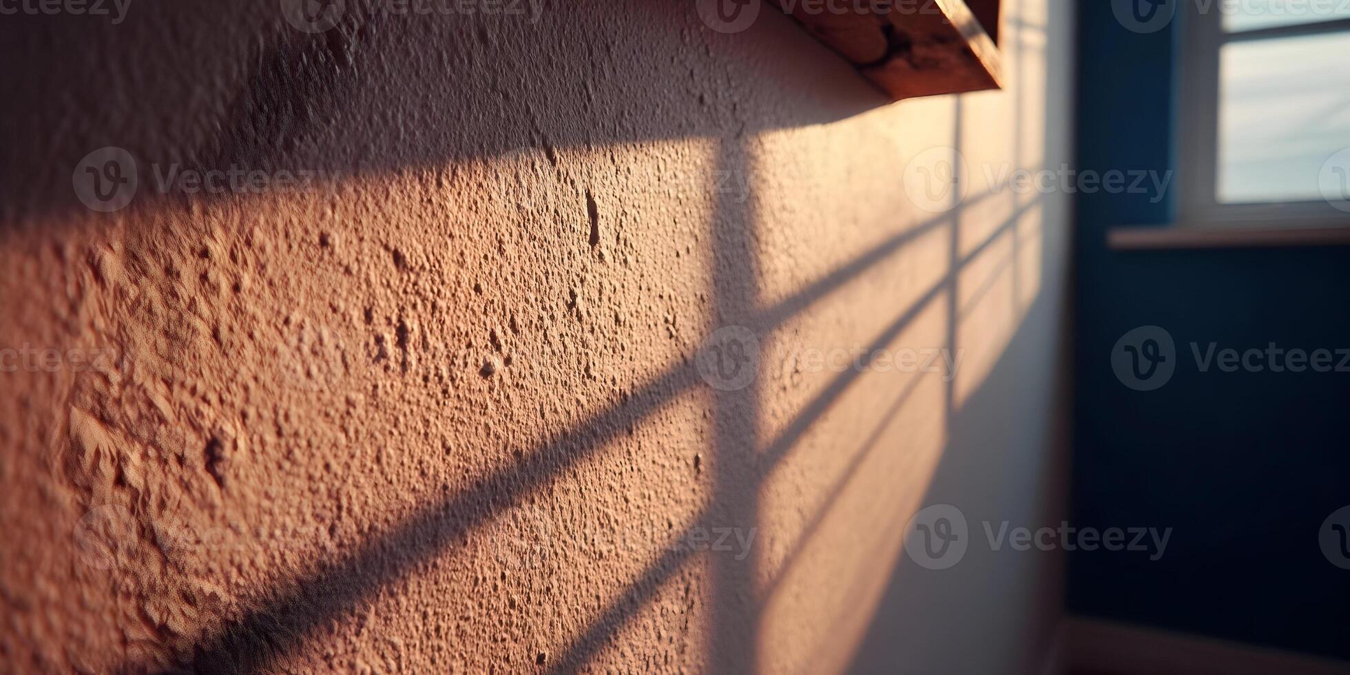 Warm Sunset Light Casting Window Shadows on Textured Wall photo