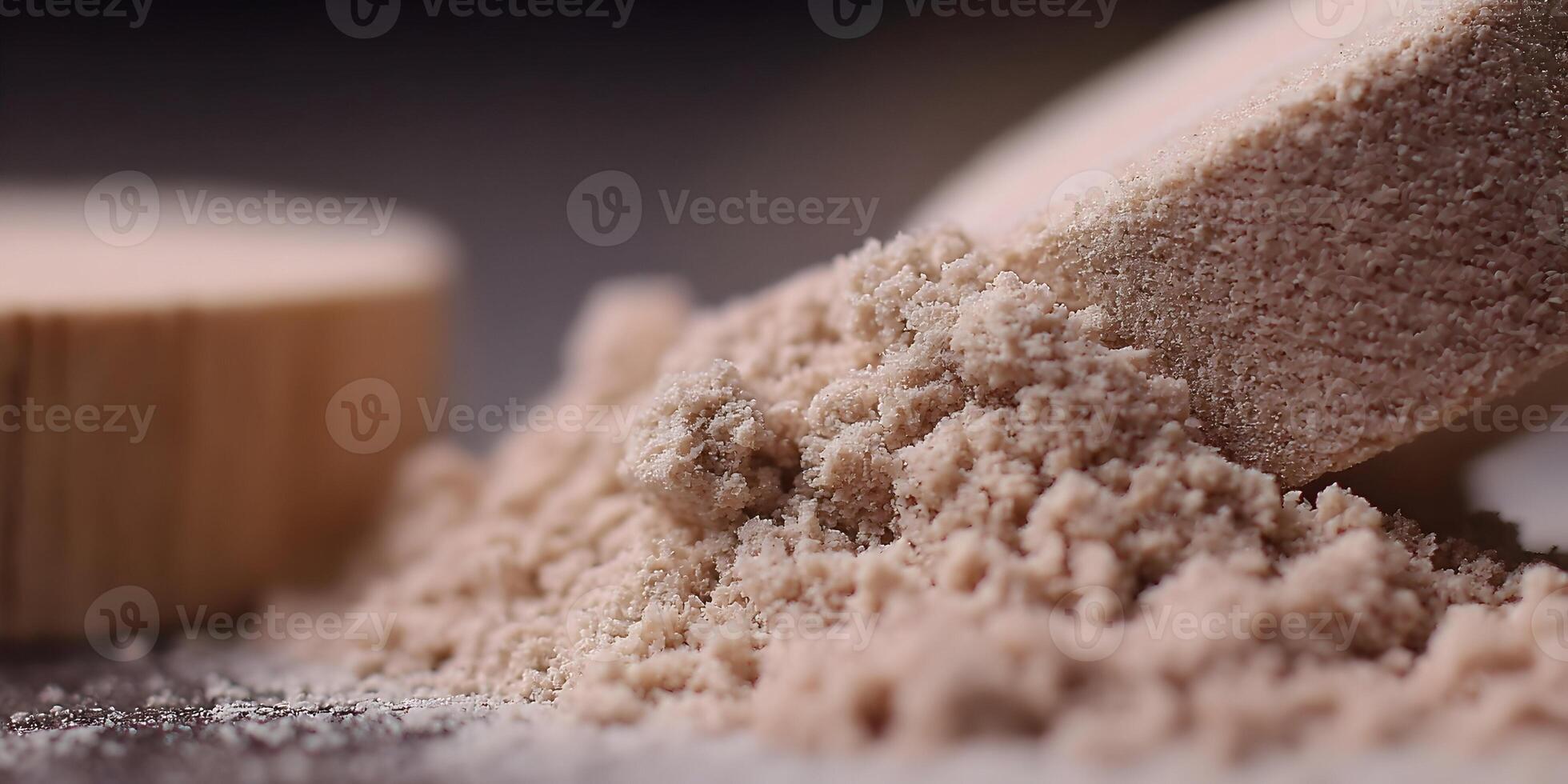 Closeup Brown Powder Grains Spilled from Wooden Scoop photo