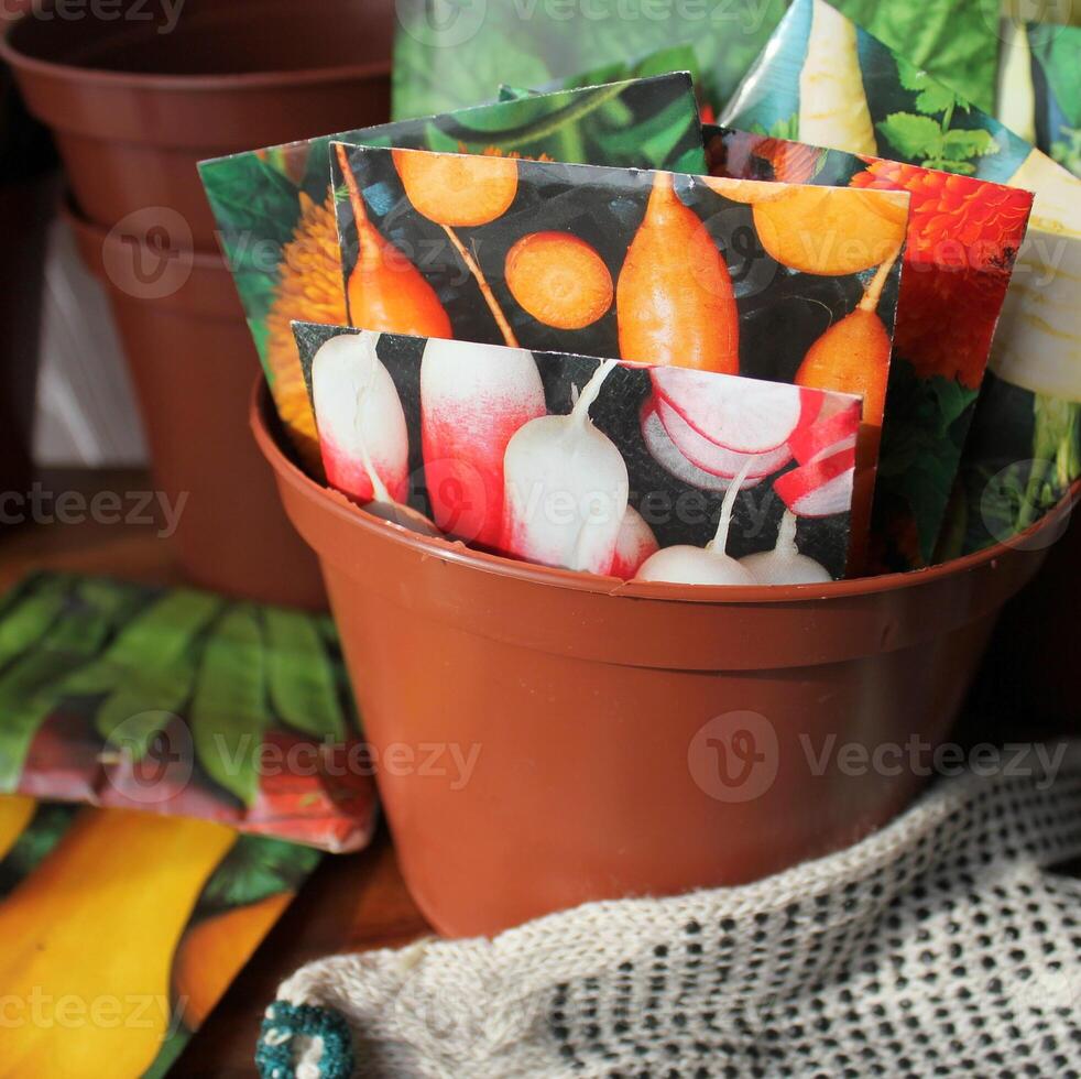 Seeds in packets in pot photo