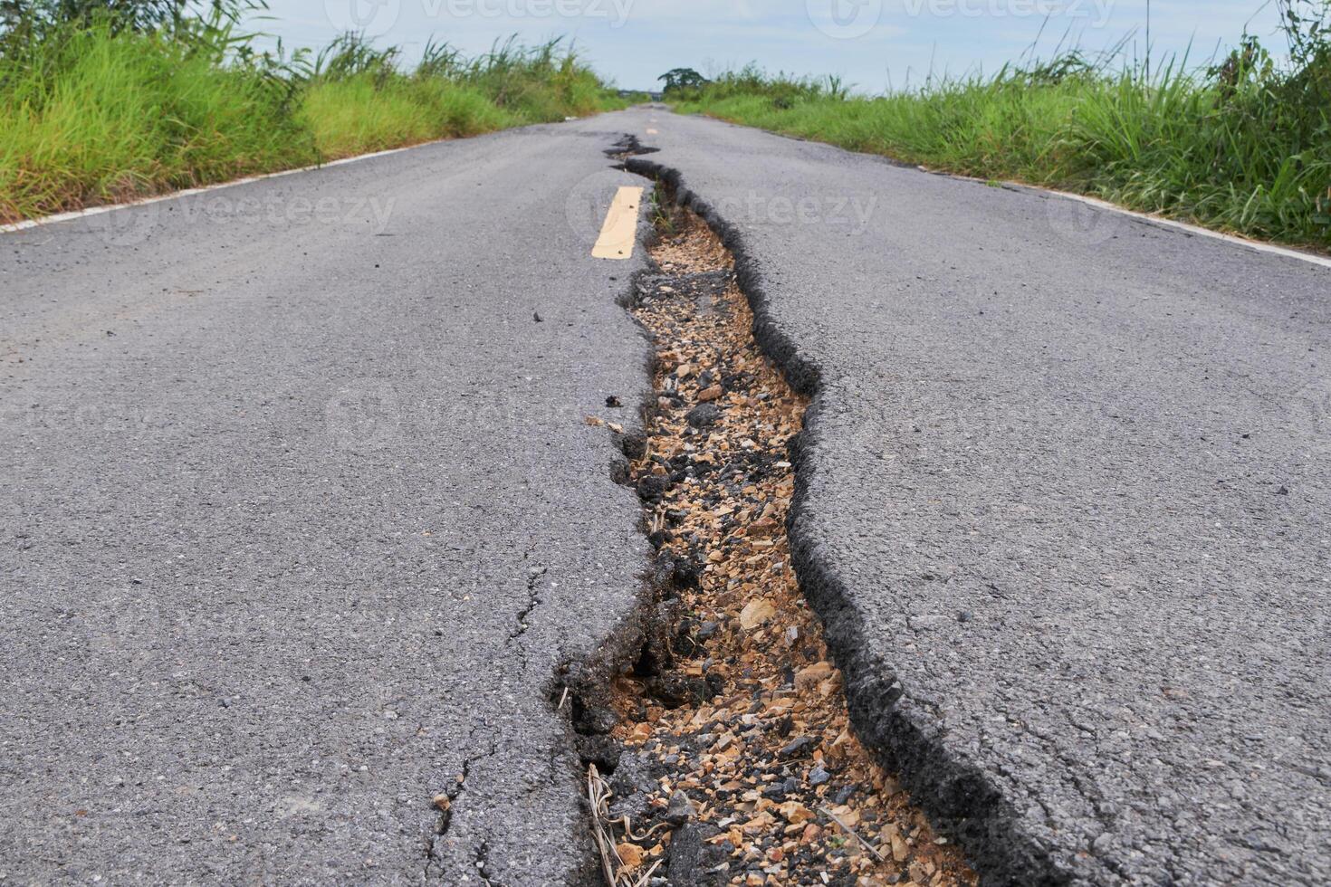 a crack in the road that is showing a crack in the road photo