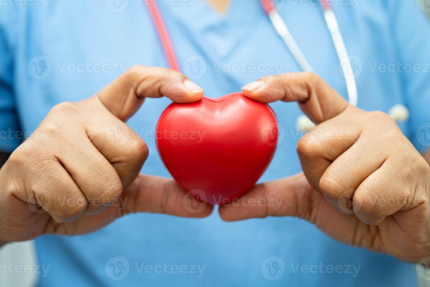 doctor holding red heart for health in hospital. photo