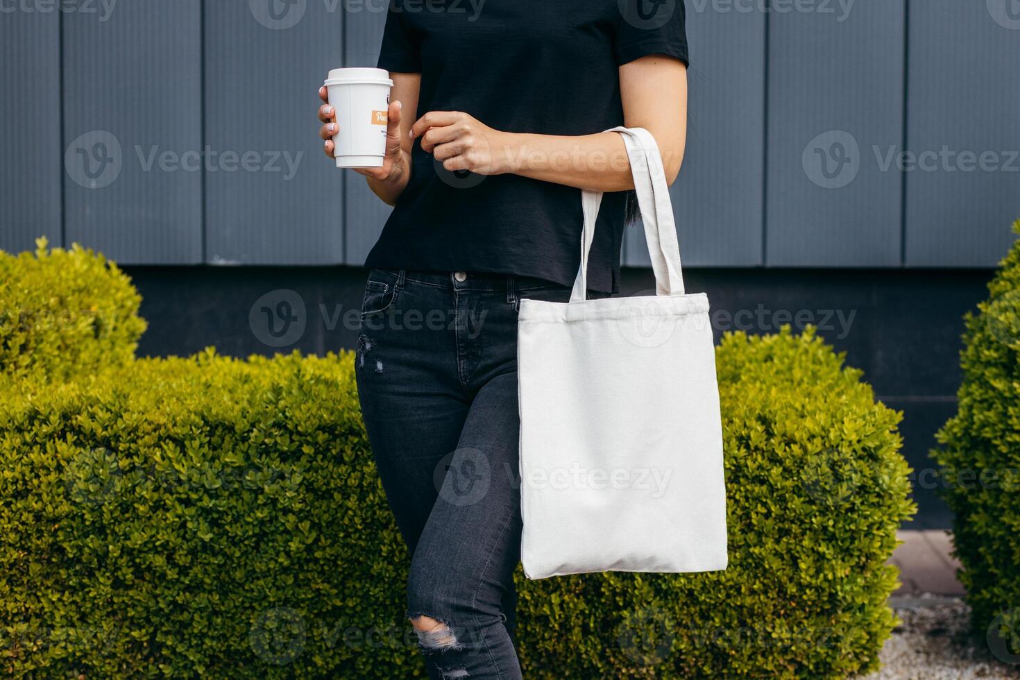 Close up girl on the street holding white eco bag photo