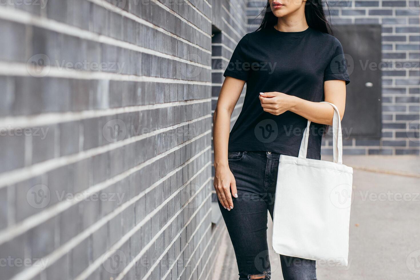 Asian girl on the street holding white eco bag, mock up. Street photo. photo