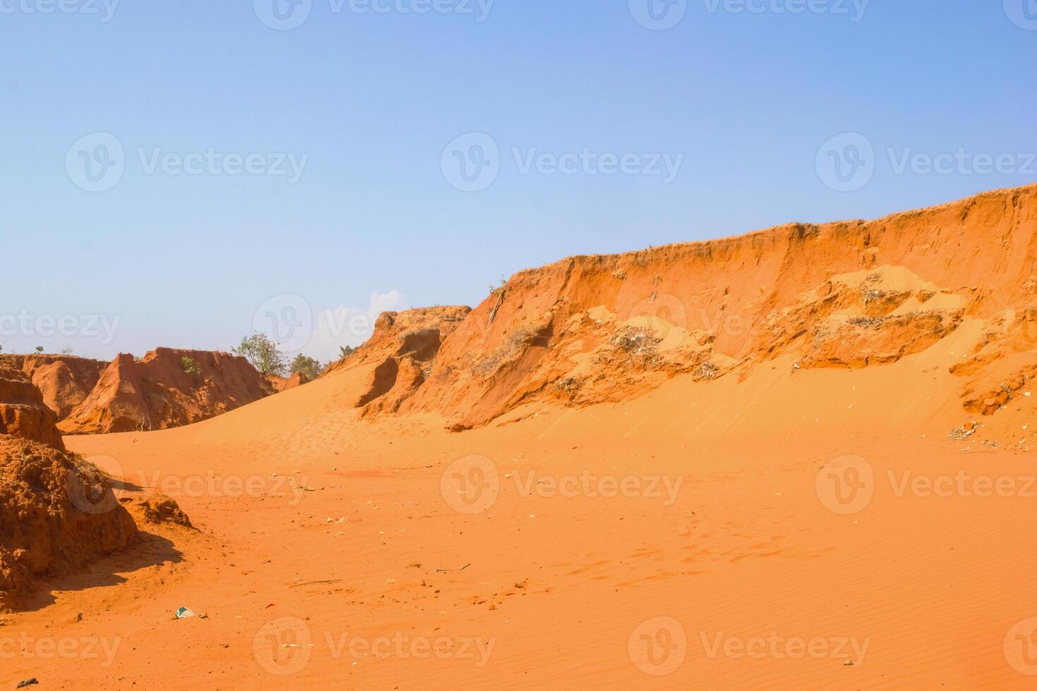 Vibrant Red Sand Dunes Landscape Under a Clear Blue Sky. Mui Ne, Vietnam, Red Canyon. photo