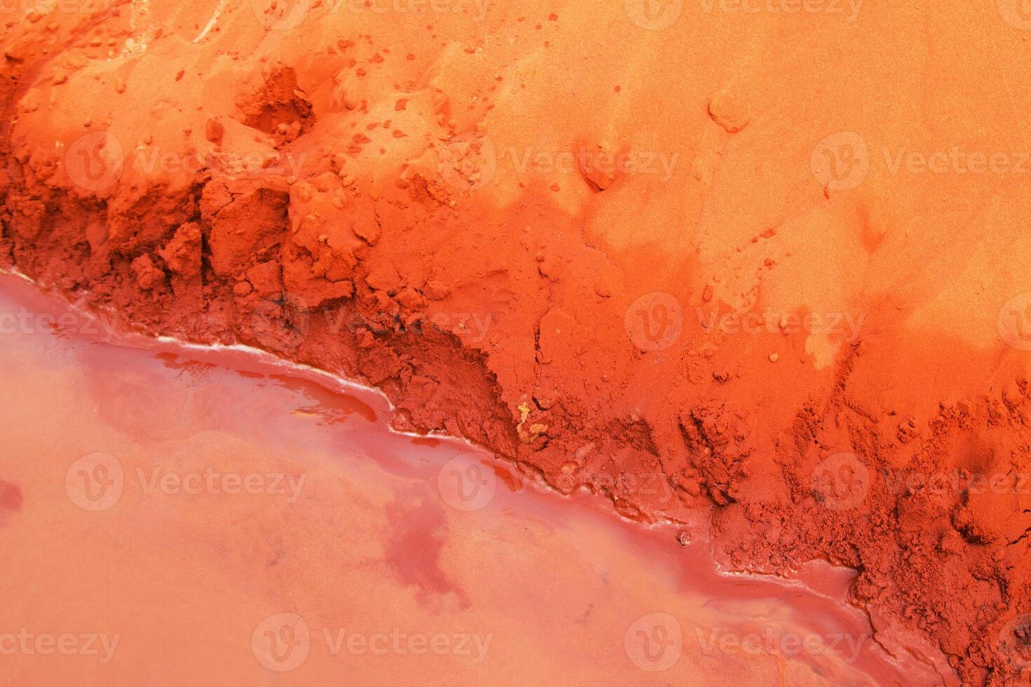 Abstract Landscape. Texture of Eroded Red Soil and Water Meeting. Mui Ne, Vietnam, Fairy Stream. photo