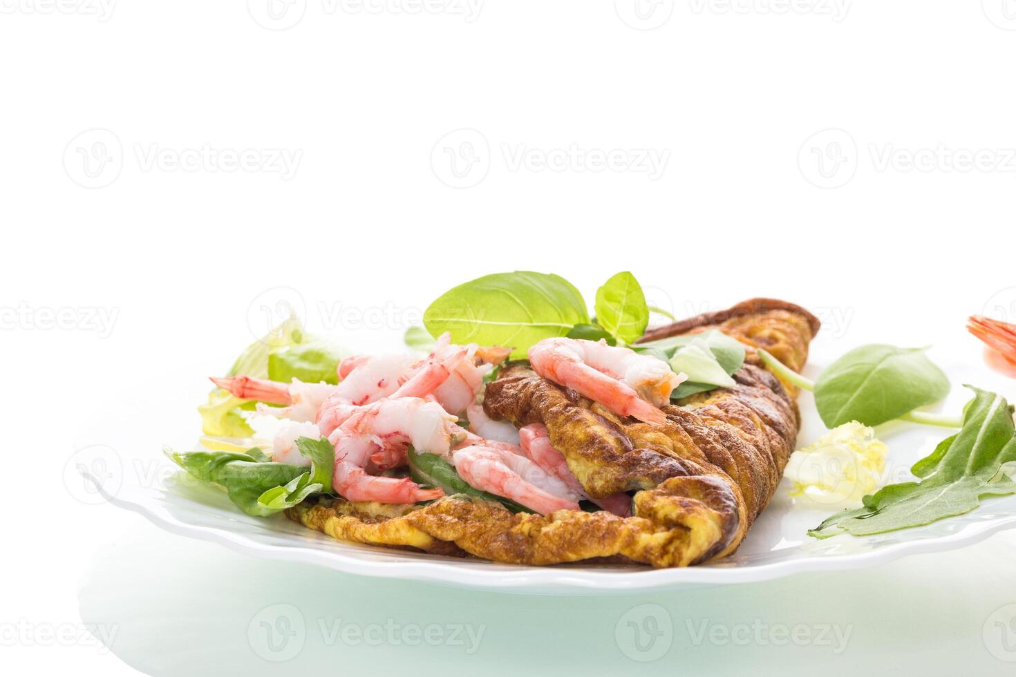 Fried omelette with shrimps and greens on a white background photo