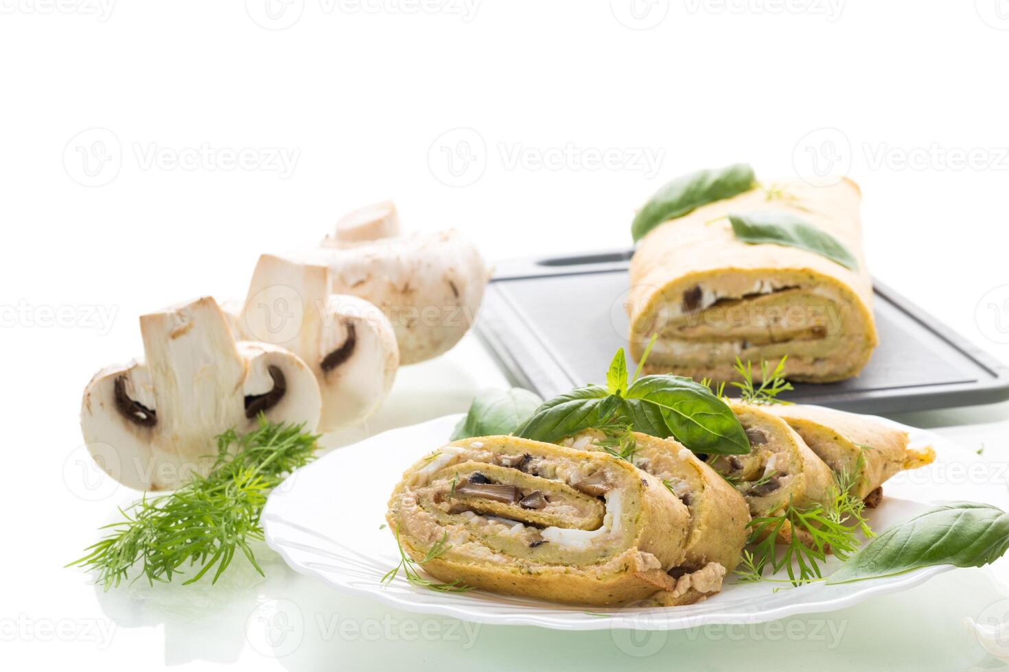Homemade zucchini roll with mushroom filling on a white background photo