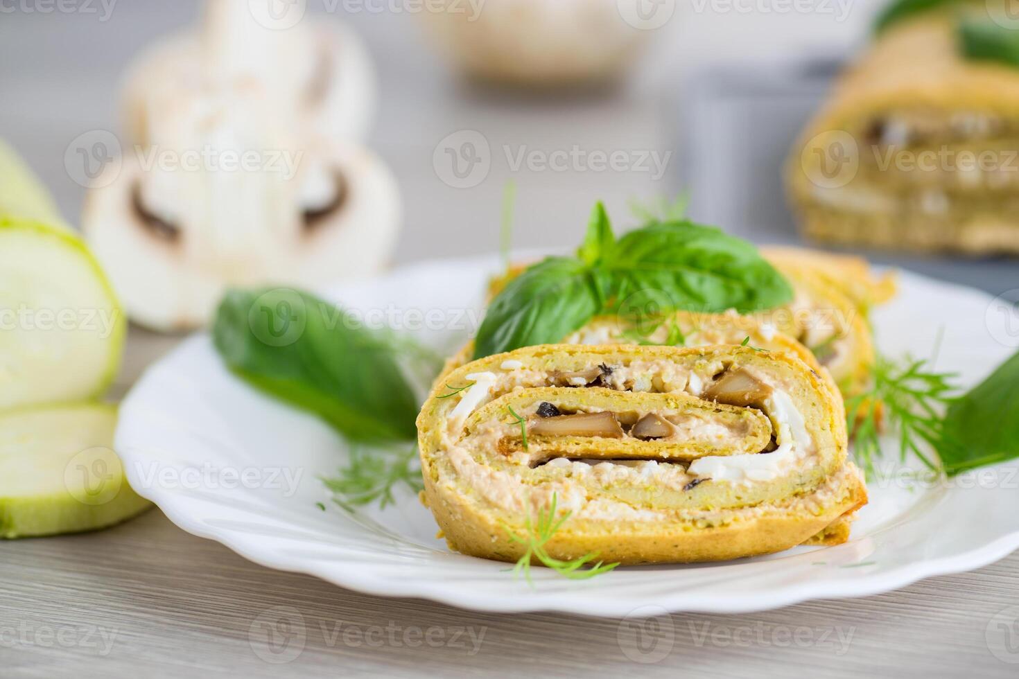 Zucchini roll on a light wooden background photo
