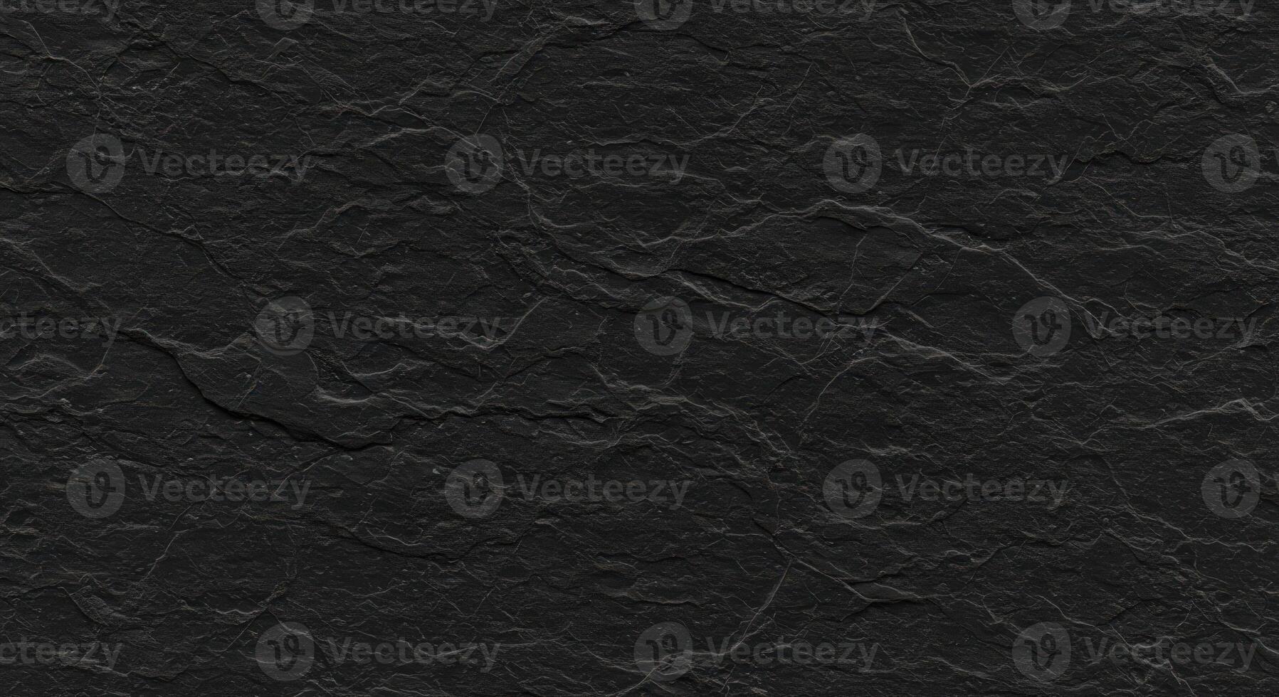 A black stone texture with a rough surface photo