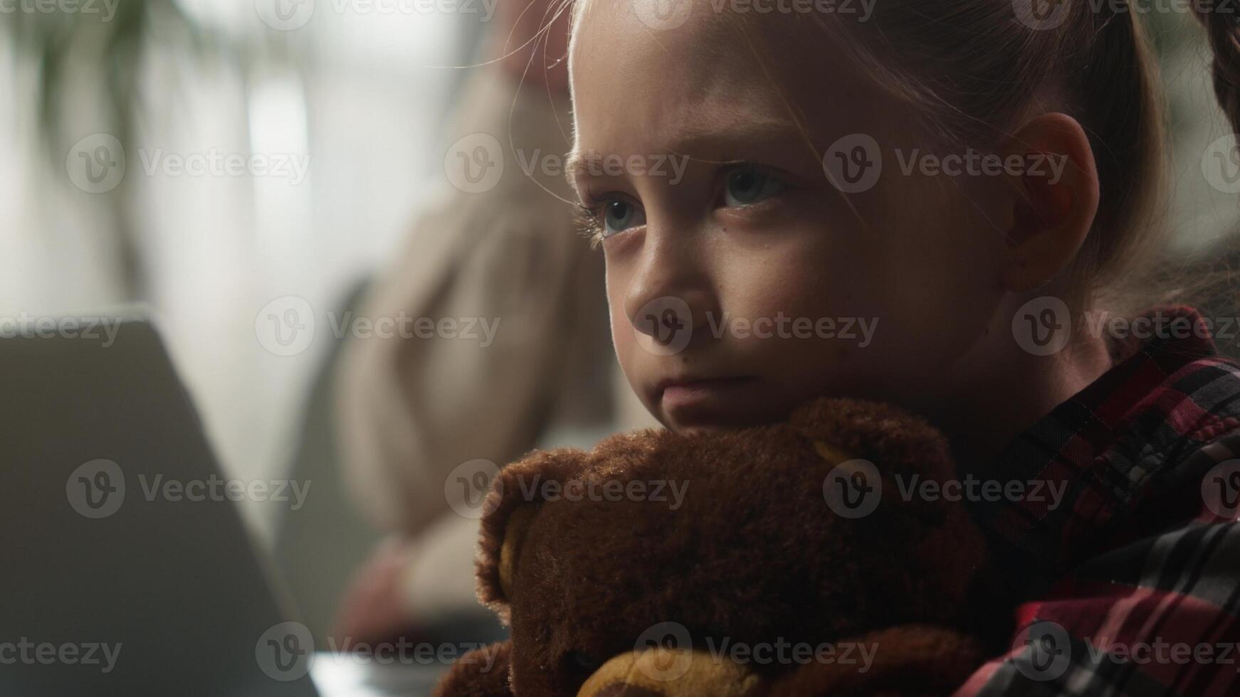 Caucasian family at home father working online with laptop ignoring sad frustrated offended upset lonely daughter hugging Teddy Bear toy child kid girl suffering dad ignorance attention deficit bored photo