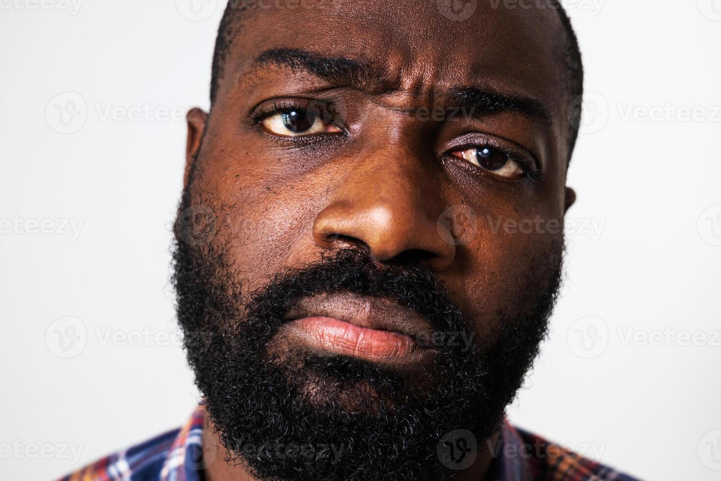 Distraught African American male, frowning with displeasure, deep in thought, symbolizing anxiety and uncertainty. photo