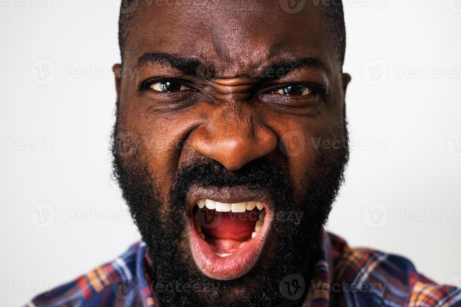 Portrait of a distraught African American man with intense expression, yelling and overwhelmed with anxiety. photo